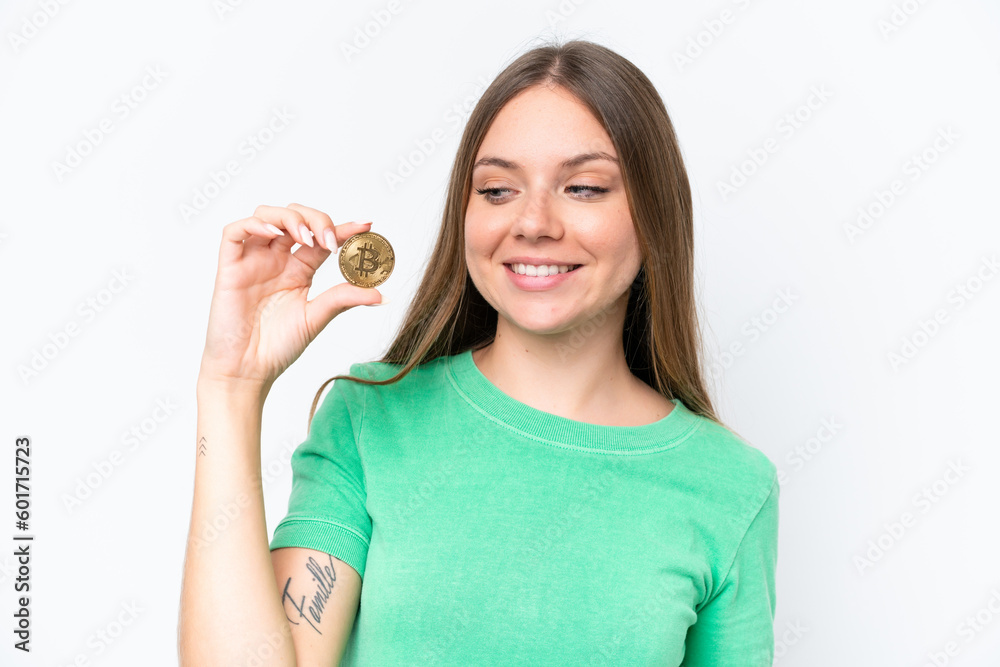 Young beautiful blonde woman holding a Bitcoin isolated on white background with happy expression Young beautiful blonde woman holding a Bitcoin isolated on white background with happy expression