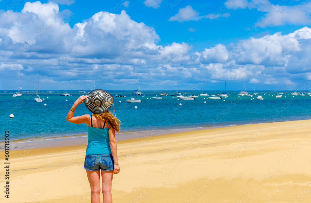 Woman enjoying view of atlantic ocean and boats- Bassin d'Arcachon, Nouvelle aquitaine, France- vacation,travel,summer holiday concept Woman enjoying view of atlantic ocean and boats- Bassin d'Arcachon, Nouvelle aquitaine, France- vacation,travel,summer holiday concept