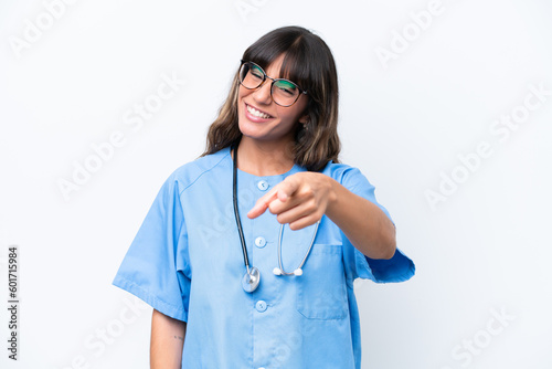 Young caucasian nurse woman isolated on white background pointing front with happy expression