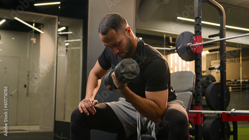 Fotografie African American man in gym doing biceps workout exercise male sportsman strong