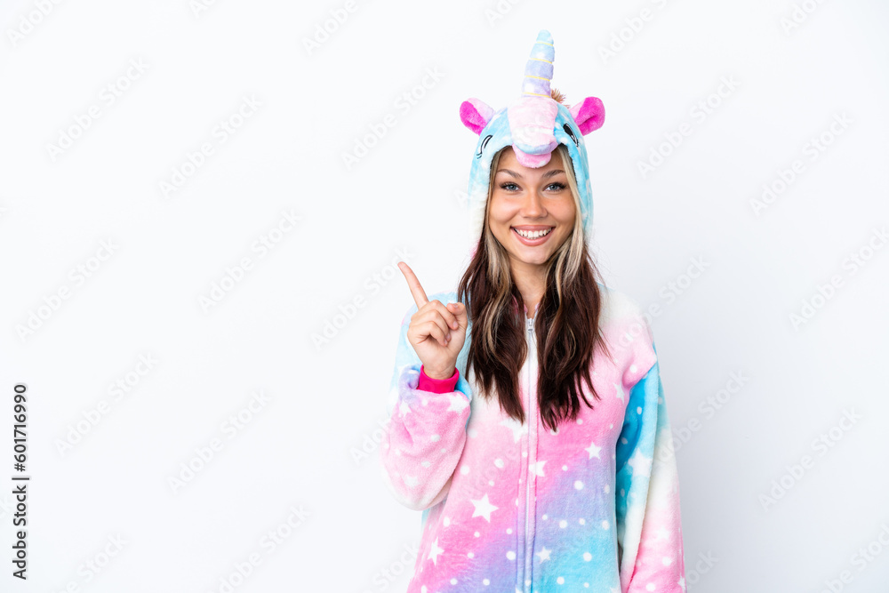 Young Russian woman wearing a unicorn pajama isolated on white background pointing to the side to present a product Young Russian woman wearing a unicorn pajama isolated on white background pointing to the side to present a product