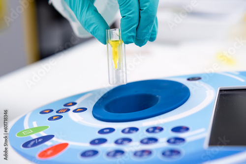 Put the cuvette into the spectrophotometer. DNA and microbiological analysis.  photo