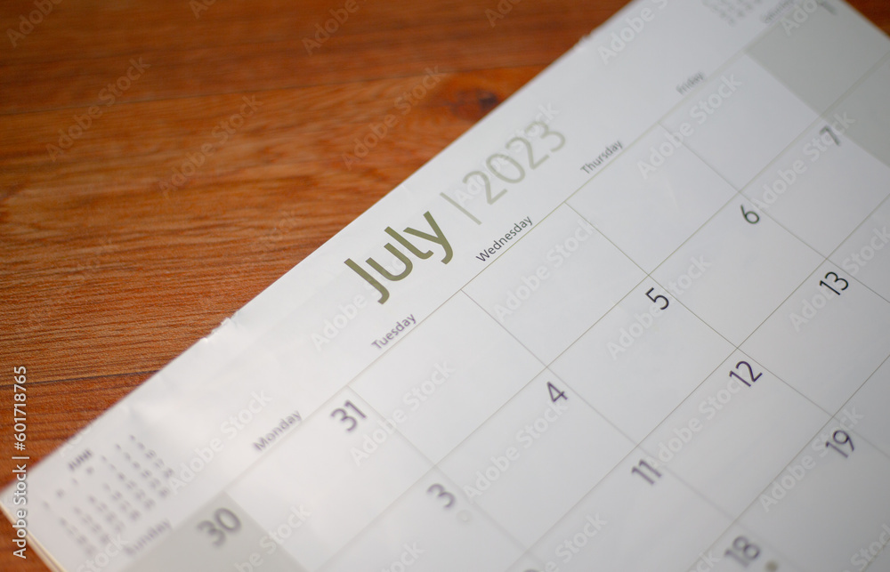 Selective focus shot of a closeup calendar of July 2023. June 2023 calendar isolated on background. Selective focus shot of a closeup calendar of July 2023. June 2023 calendar isolated on background.