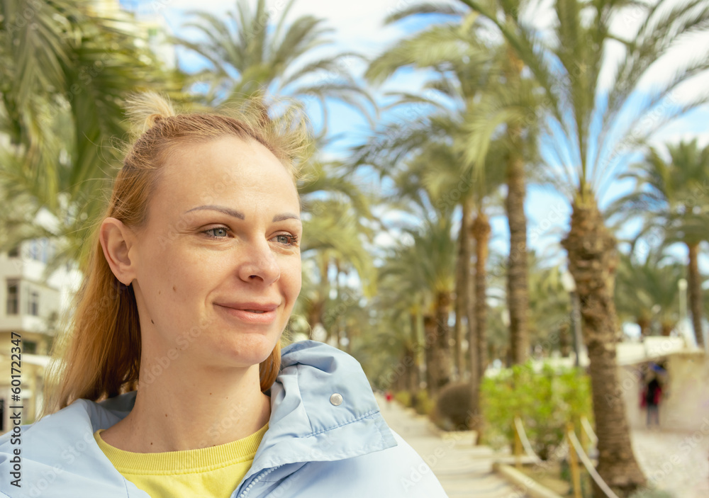 portrait of a girl on the embankment around the palm tree portrait of a girl on the embankment around the palm tree