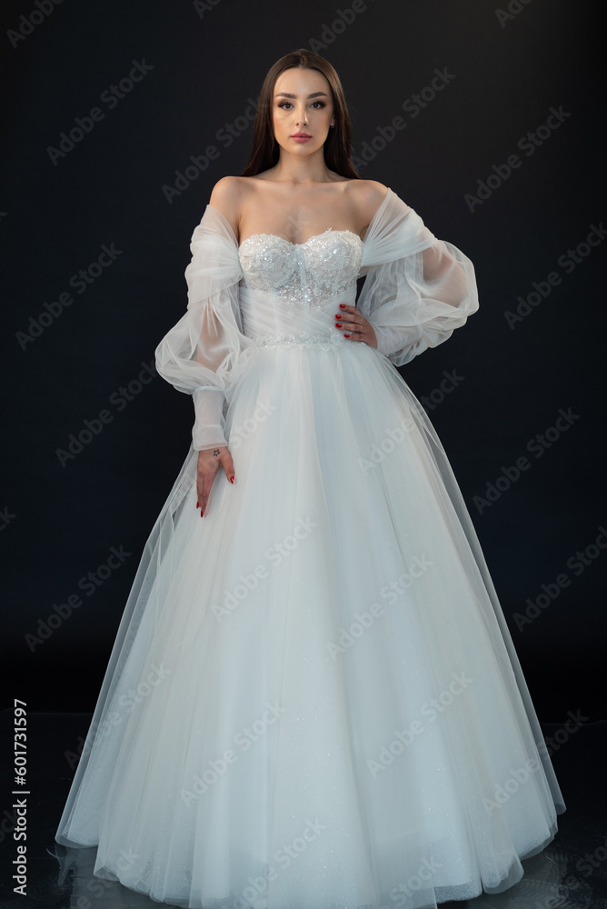 Perfect bride in wedding dress on black background