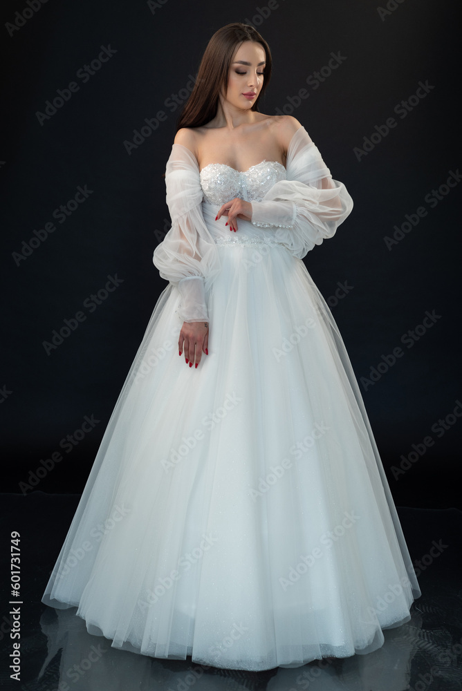 Perfect bride in wedding dress on black background
