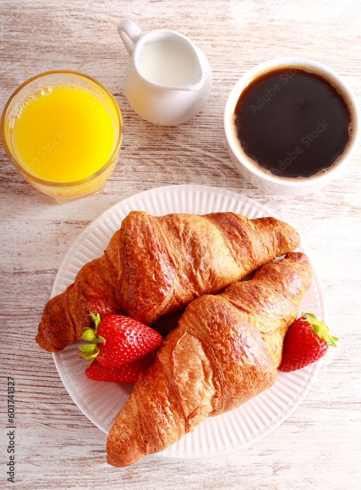 Breakfast set with croissants, orange juice