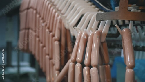 industrial production of sausages. Hanging sausages. Sausage production line, sausages hanging in row.