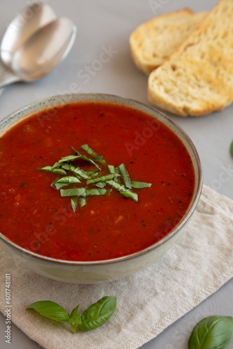 Homemade Tomato Basil Soup in a Bowl, side view. Close-up.