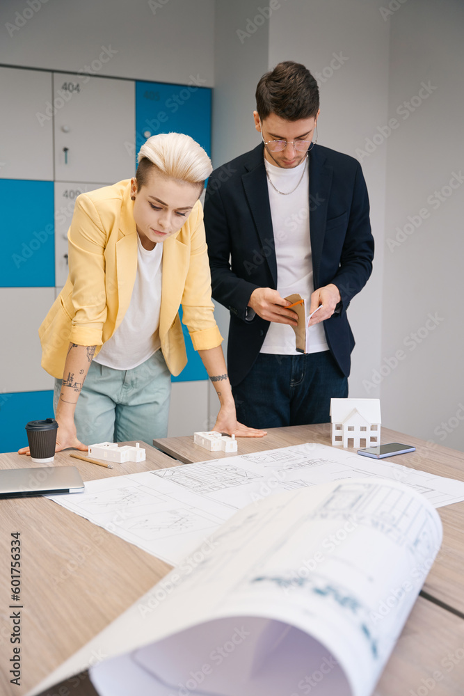 Fototapeta premium Architects studying house blueprint in the office