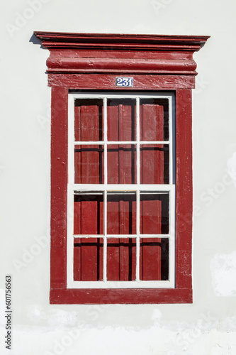 Old window with the number 231 at the top in red and white, vintage style. Historic city of Sabara. Minas Gerais. Brazil.