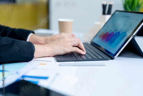 Woman working at home office hands on keyboard close-up