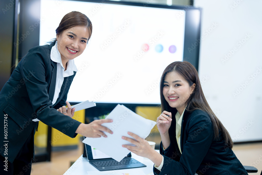 Business women discussing in conference room during meeting at office Business women discussing in conference room during meeting at office
