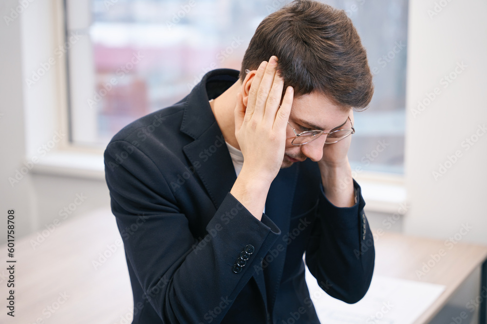 Man is massaging sore temples, feeling headache Man is massaging sore temples, feeling headache