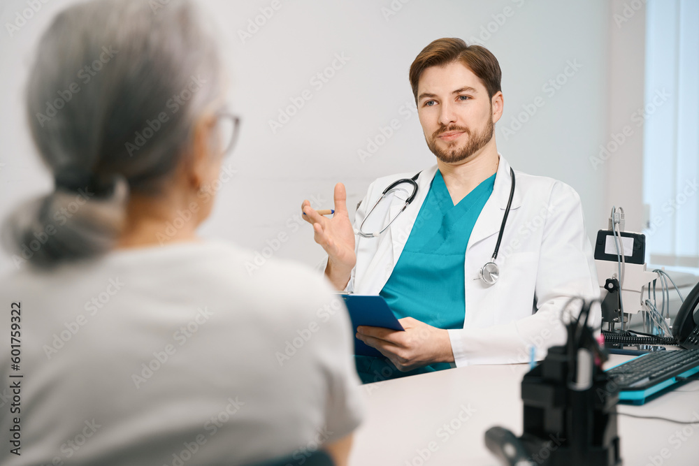 Young therapist consults an elderly lady in a medical center Young therapist consults an elderly lady in a medical center