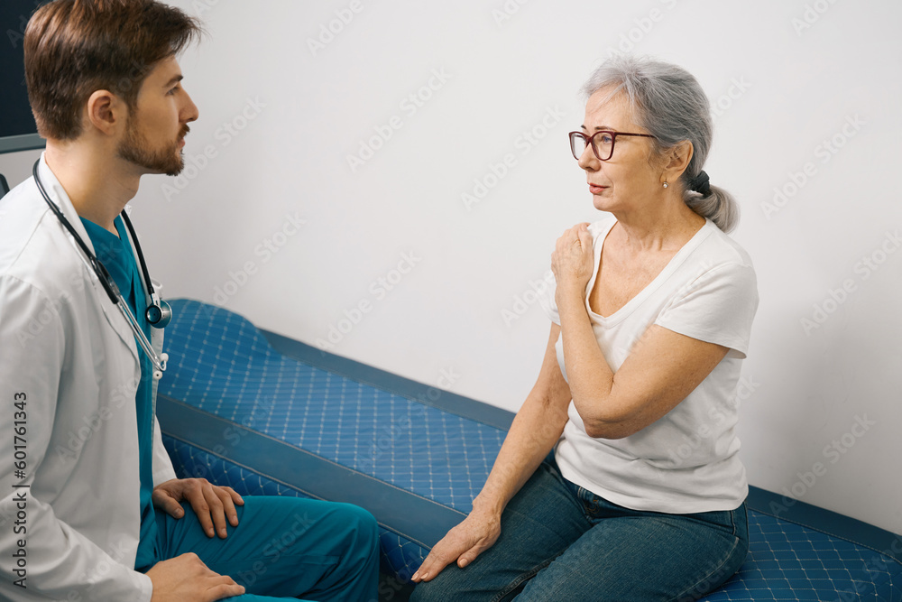 Elderly lady at the appointment with traumatologist in medical center Elderly lady at the appointment with traumatologist in medical center