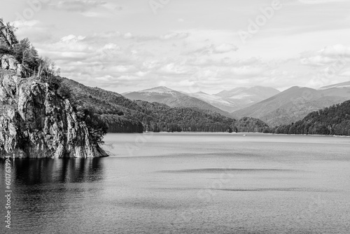 Vidraru Lake, an artificial reservoir lake used for hydroelectricity production in Fagaras Mountains, Carpathian Mountains, Arges county, Walachia, Romania in black and white