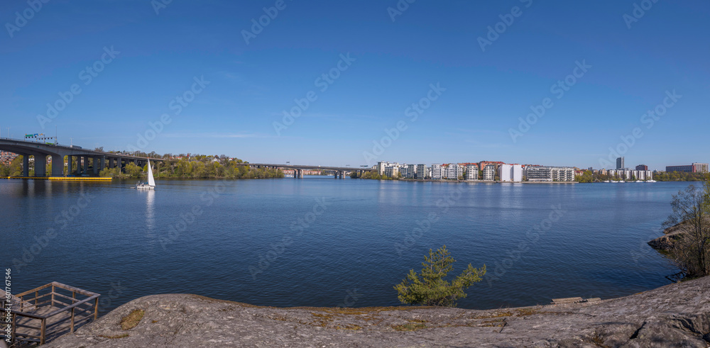 Panorama. The bay Essinge islands in the sea Mälaren , high way passing and waterfront houses, a sailing boat passing  to the archipelago, an sunny early  summer day in Stockholm