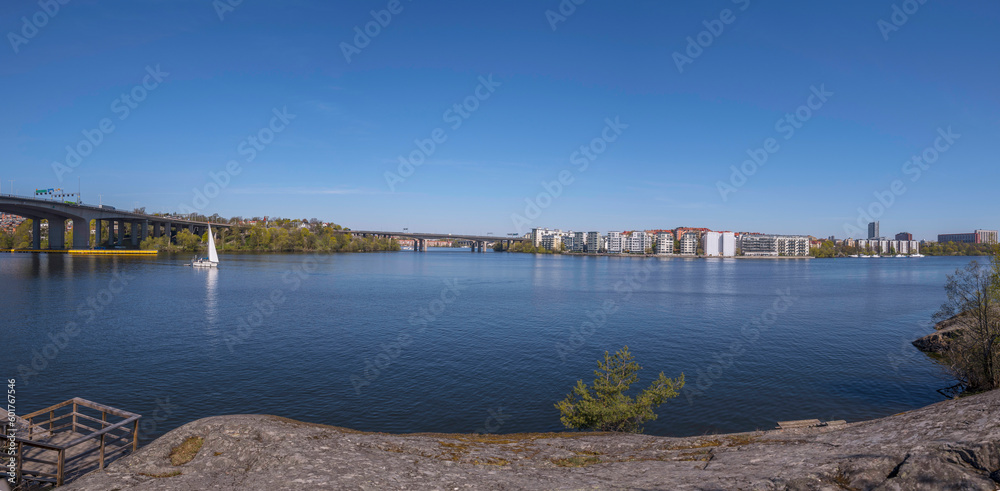 Obraz premium Panorama. The bay Essinge islands in the sea Mälaren , high way passing and waterfront houses, a sailing boat passing to the archipelago, an sunny early summer day in Stockholm