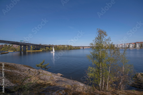 Panorama. The bay Essinge islands in the sea Mälaren , high way passing and waterfront houses, a sailing boat passing to the archipelago, an sunny early summer day in Stockholm