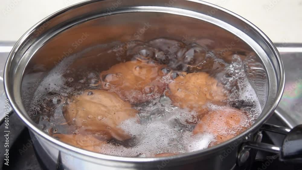 Chef is boiling eggs in a pot slow motion