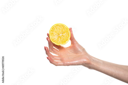 The girl's hand holds a cut round slice of fresh tropical orange. An orange in a woman's hand on a white background is isolated. Orange slice. The girl gently holds a citrus in hand