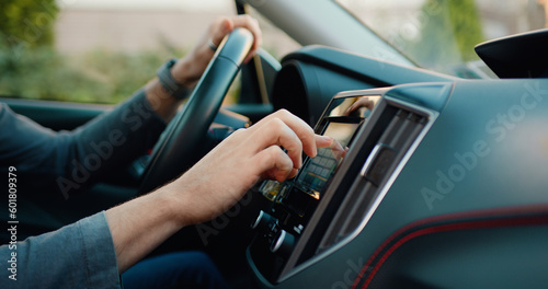 Side view of caucasian male hand which typing needed coordinates on navigator touchscreen with modern assistance functions.