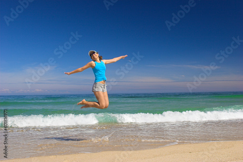 Beautiful young woman jumping on a beautiful beach © Designpics
