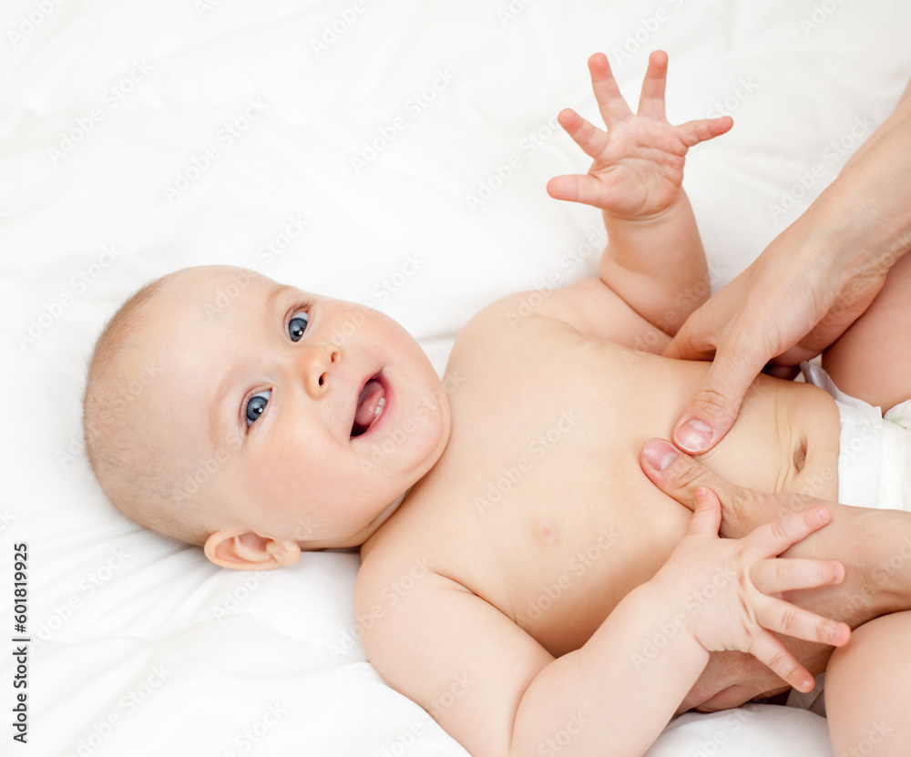 Mother massaging her child, shallow focus Mother massaging her child, shallow focus