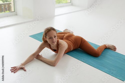 A beautiful girl is engaged in a yoga studio