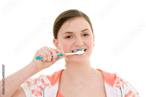 Caucasian teenager brushing her teeth on white background