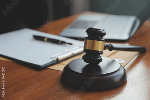 Business and lawyers discussing contract papers with brass scale on desk in office. Law  legal services  advice  justice and law concept picture with film grain effect