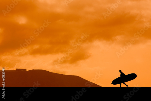 A longboarder silhouetted against the sunset sky © Designpics
