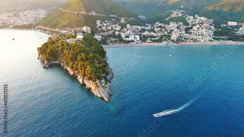 Bird's eye view of towns of Budva and Becici with hotels and beaches near Adriatic Sea against the backdrop of the Montenegrin Mountains photo