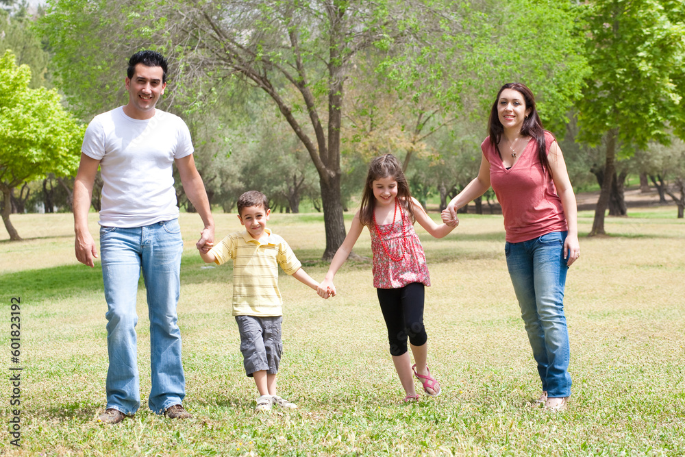 Family posing to camera in the park,outdoor Family posing to camera in the park,outdoor
