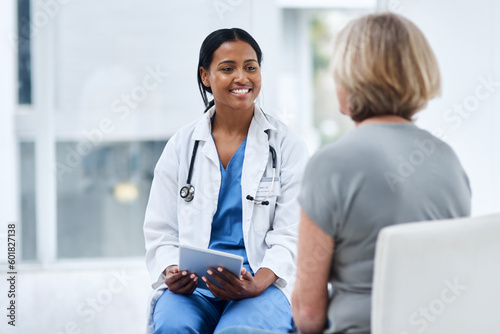 Women, patient and doctor with a tablet, consultation and conversation for diagnosis, cure and treatment. Medical professional, employee and female person in a hospital, technology and discussion photo