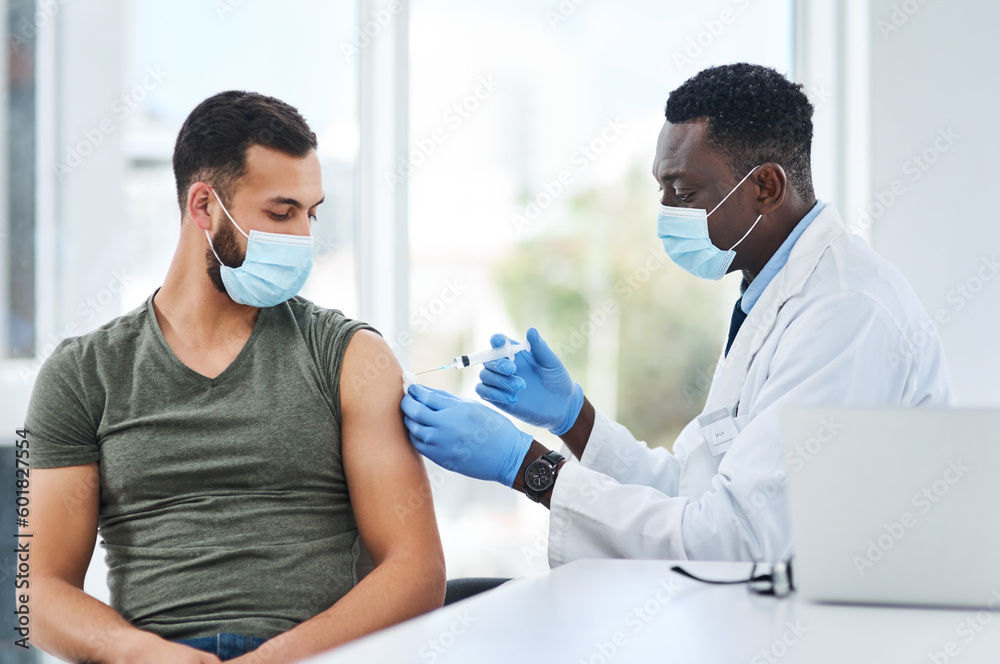 Obraz premium Covid, vaccine and man doctor with syringe in healthcare consultation for safety or prevention. Corona, vaccination and arm injection for guy person by physician in face mask for hospital compliance