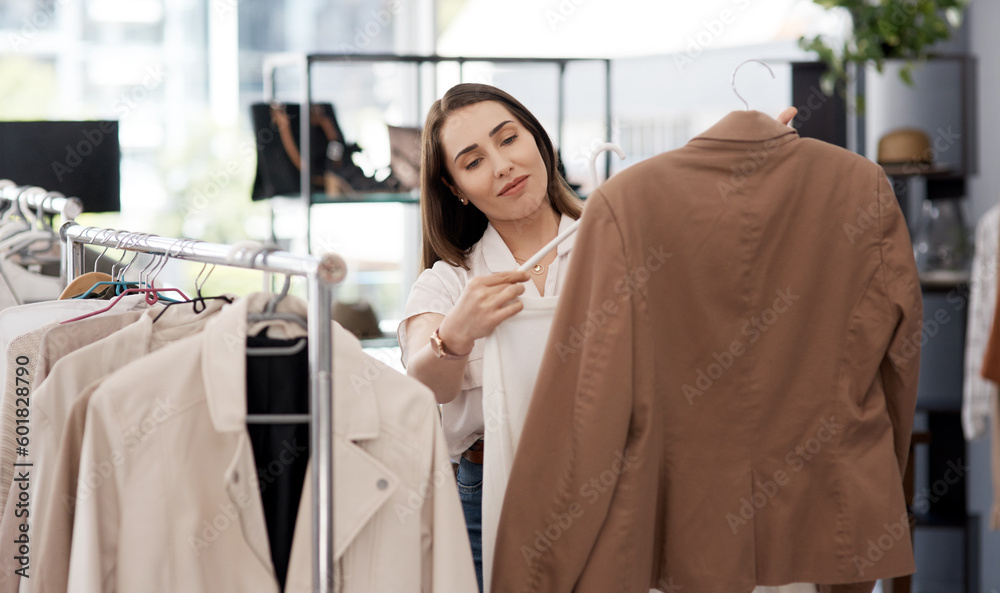 Obraz premium Shopping, retail and a woman customer in a mall boutique to buy trendy clothes for seasonal fashion. Search, store and sale with a young female consumer in a shop, making a clothing purchase choice