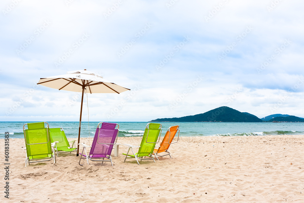 Colorful chairs and umbrellas on the empty beach. Colorful chairs and umbrellas on the empty beach.