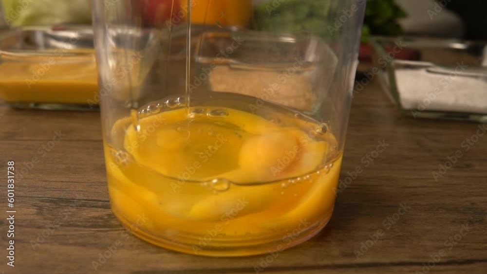 Broken raw egg falls into blender glass Broken raw egg falls into blender glass