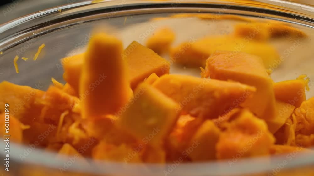 Pumpkin cut into small pieces poured into a bowl Pumpkin cut into small pieces poured into a bowl