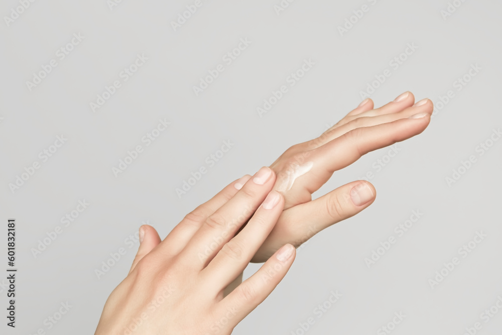a woman applies a cosmetic cream on her hands. hand skin care concept a woman applies a cosmetic cream on her hands. hand skin care concept