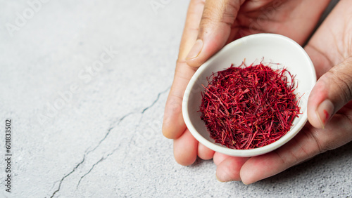 Fototapeta Naklejka Na Ścianę i Meble -  Kashmiri saffron in white bowl place in hand