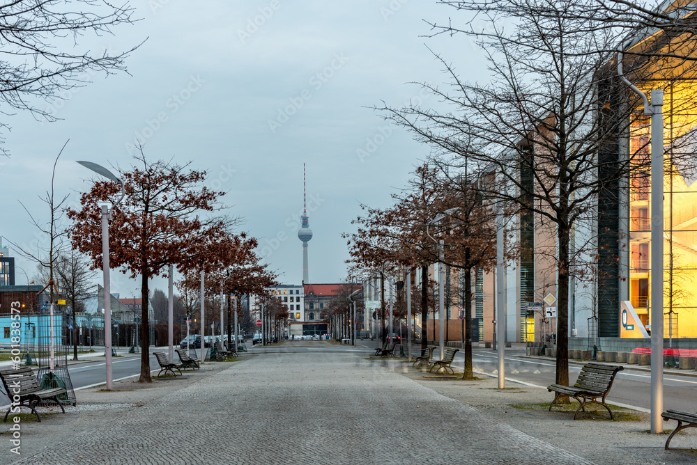 Winter trees besides walkway leading  towards TV tower in Berlin, Germany
