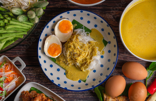 Rice noodles with fish curry sauce and spicy curry sauce  southern style with vegetables set  fried chicken  boiled egg and pickled vegetables  Thai traditional style.  Kanom Jeen Nam Ya 