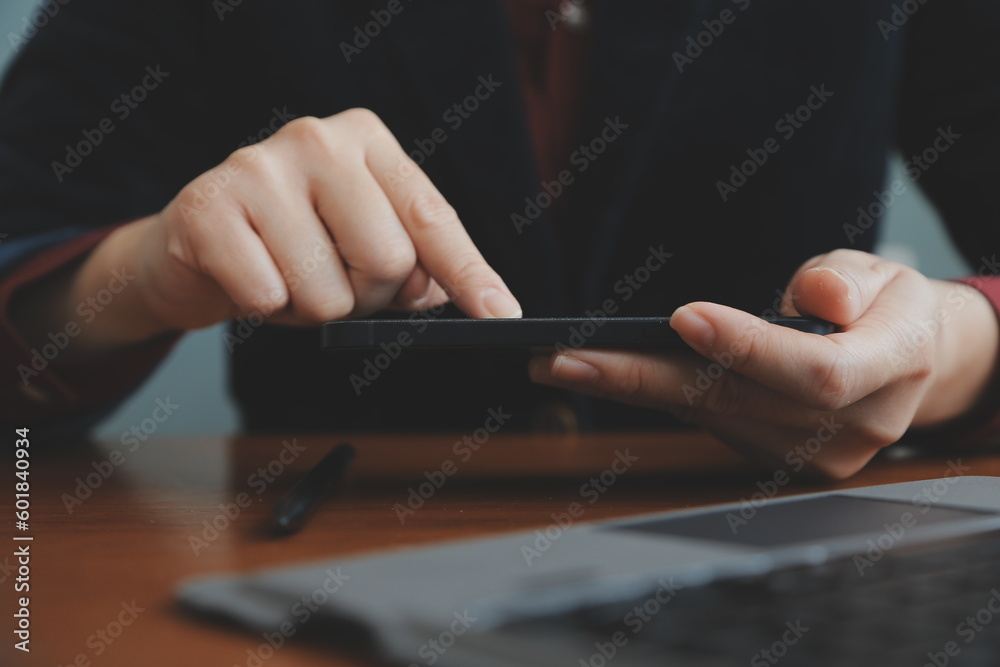 Asian Businesswoman Using laptop computer and working at office with calculator document on desk, doing planning analyzing the financial report, business plan investment, finance analysis concept. Asian Businesswoman Using laptop computer and working at office with calculator document on desk, doing planning analyzing the financial report, business plan investment, finance analysis concept.