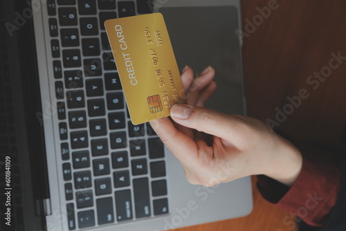 Women holding credit card and using smartphones at home.Online shopping, internet banking, store online, payment, spending money, e-commerce payment at the store, credit card, concept