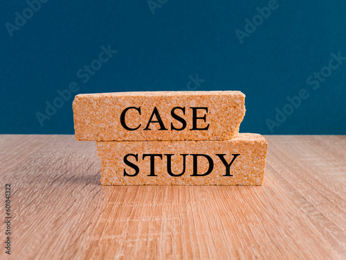 Case stady symbol. Concept words Case stady on brick blocks. Beautiful wooden table dark blue background. Business and Case stady concept. photo