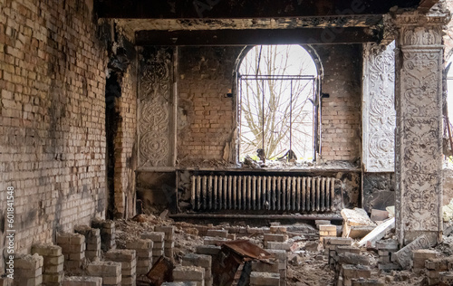 The bombed building of the house of culture in the city. War of Russia against Ukraine. Destroyed floor beams inside the building, which was hit by an artillery shell, rocket or air bomb. photo