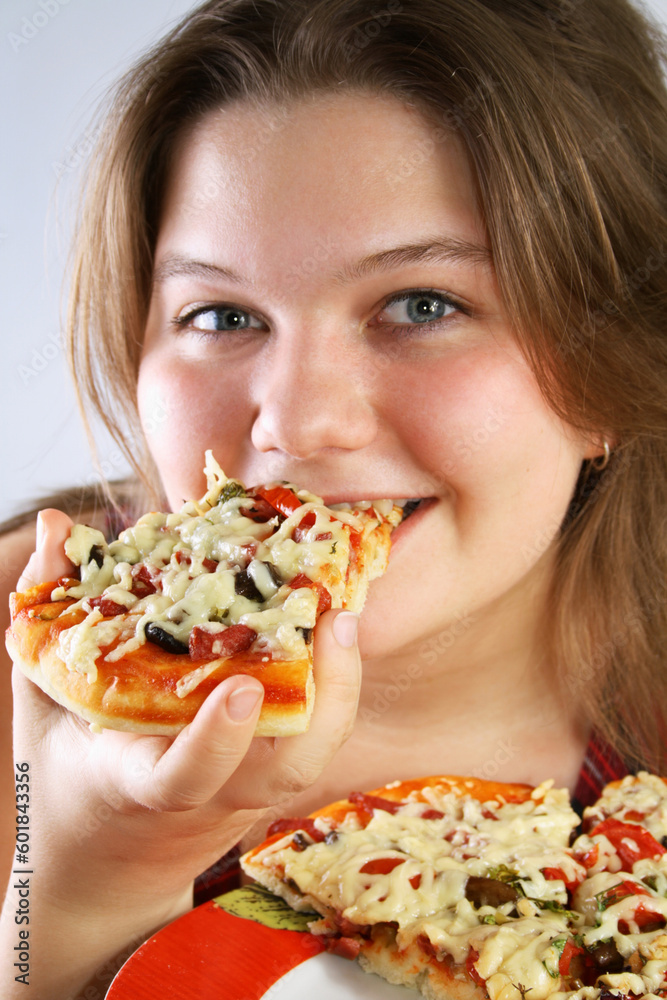 Beautiful no make-up girl eating a piece of Pizza Beautiful no make-up girl eating a piece of Pizza